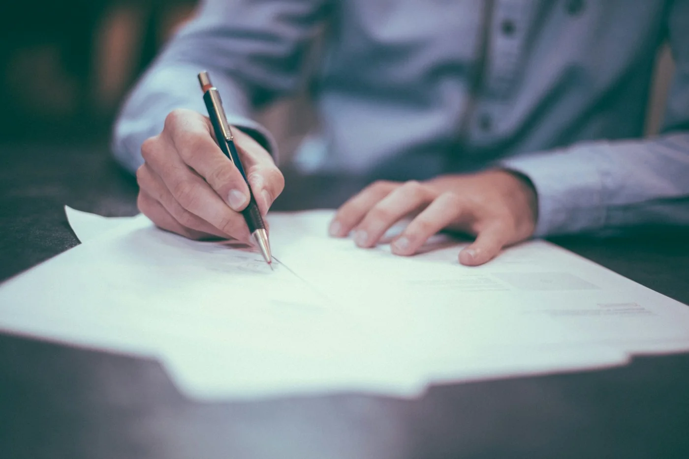 Completing application paperwork at a desk