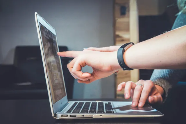 Reviewing an online offer carefully on a laptop